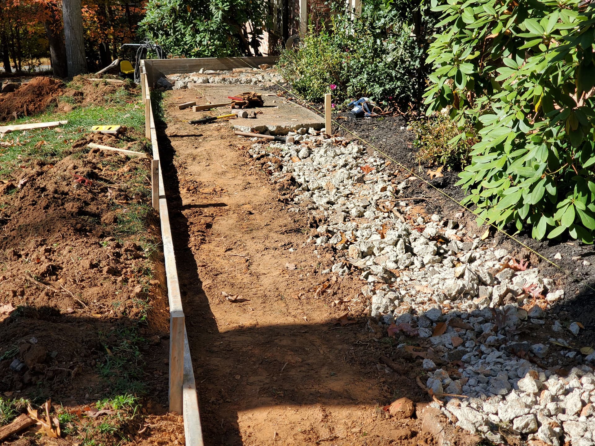 Gallery photos for Cracked Sidewalk Gone - Stamped Patio and Stone Wall Built Right: Image #2